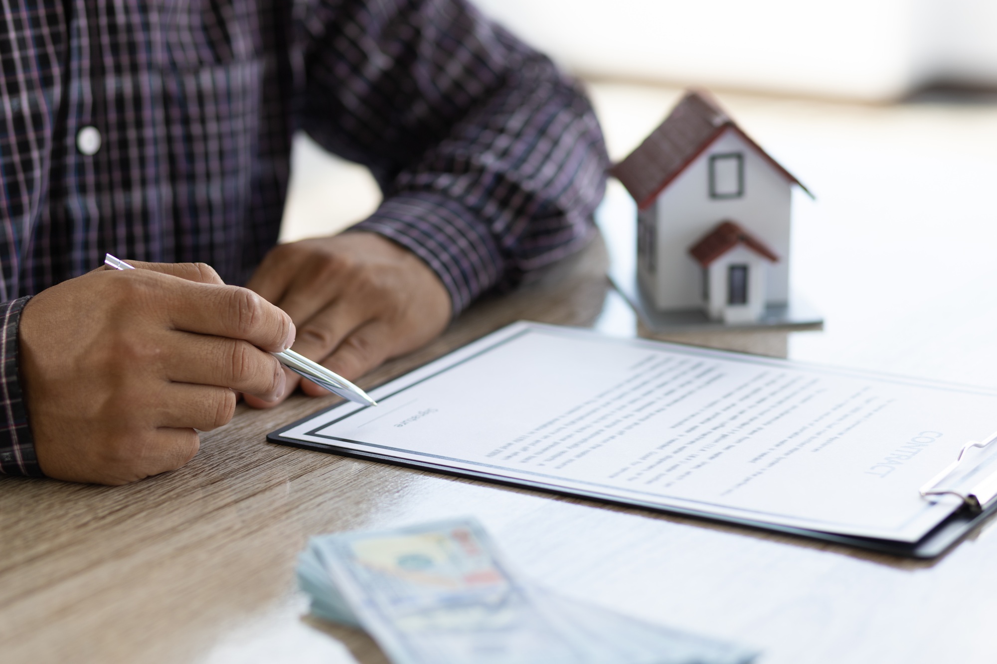 Real estate loan and mortgage contract agreement signing concept.